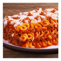 Lasagna with meat and sauce on a white plate and wooden table top.