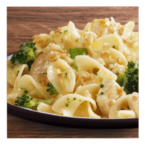 Chicken and broccoli pasta bake on a white plate and wooden table top.