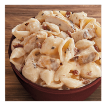 Chicken Bacon Ranch Pasta in a white bowl on a wooden table top.
