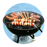 Close up of multiple skewers on top of a round barbecue grill, on a blue background.