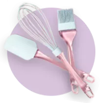 Pink and blue spatula, whisk and pastry brush on a purple circle.