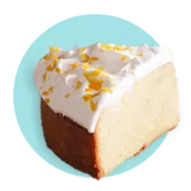 Una rebanada de pastel tres leches sobre un círculo azul.