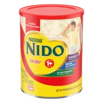 A yellow canister of Nido 1+ with a red label and lid above a young boy clapping.
