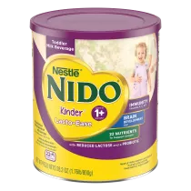 A canister of Nido Lacto-Ease with a purple label and lid above a young boy smiling.