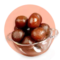 A bowl of gulab jamun on an orange circle.