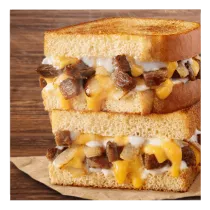 A Double Steak Cheddar Melt-FULLS® on a wood surface.