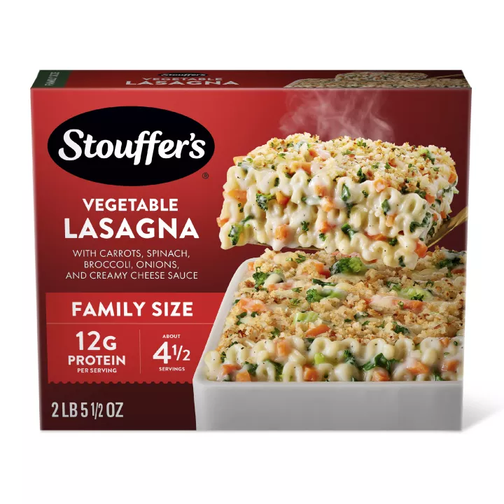 Box of Veggie Lovers Lasagna with a plate and dish of lasagna on a table with the product name and "FAMILY SIZE" label.